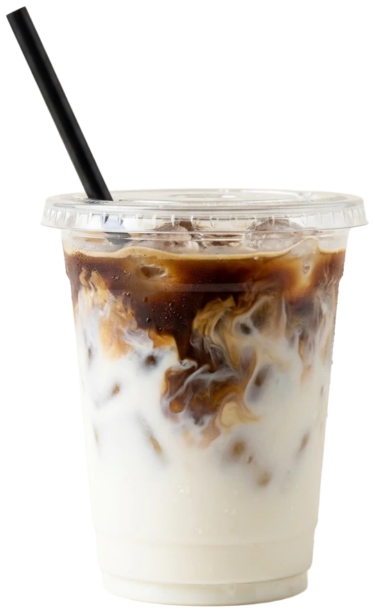 Iced latte in a clear cup with a black straw, espresso swirling into the milk